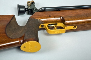 A gold anodised pistol grip cap fitted to an Anschutz LG250
